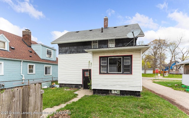 1017 W Oakland Ave, Lansing, MI 48915 - back of house with a chimney