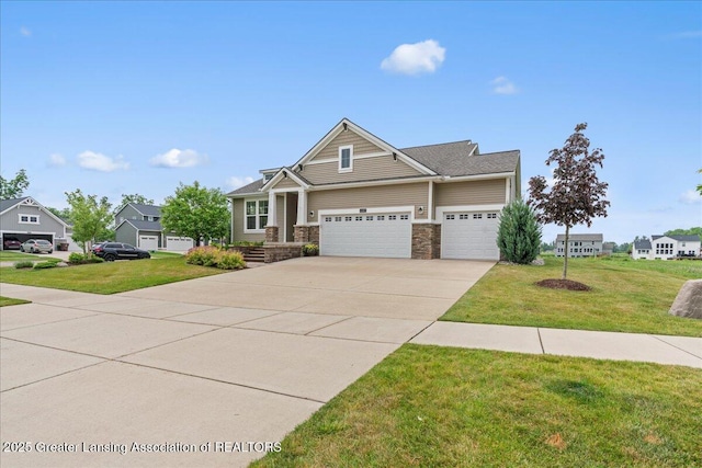 11167 Windswept Dr, Grand Ledge, MI 48837 - view of front of house featuring a garage, driveway, a front lawn, and stone siding