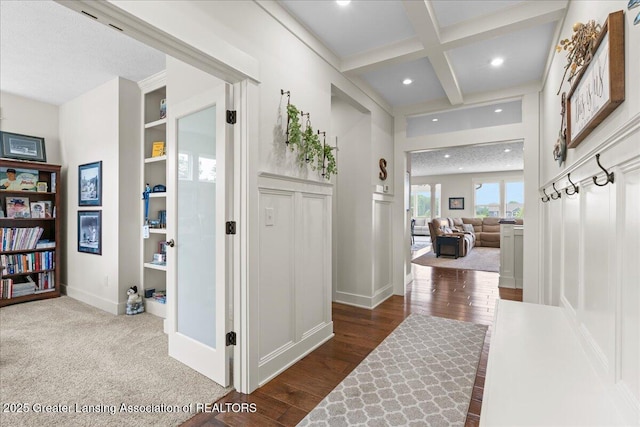 11167 Windswept Dr, Grand Ledge, MI 48837 - corridor featuring coffered ceiling, beam ceiling, wood finished floors, recessed lighting, and built in features