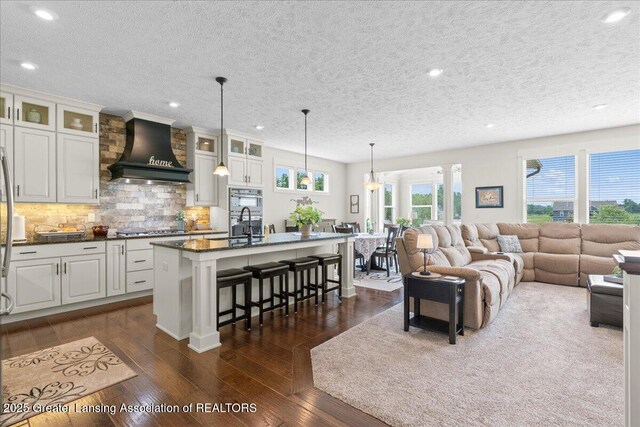 11167 Windswept Dr, Grand Ledge, MI 48837 - living area featuring a textured ceiling, recessed lighting, and dark wood-type flooring
