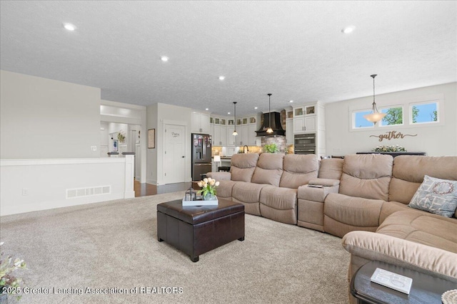 11167 Windswept Dr, Grand Ledge, MI 48837 - living area with recessed lighting, light colored carpet, and a textured ceiling