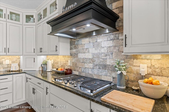 11167 Windswept Dr, Grand Ledge, MI 48837 - kitchen featuring custom exhaust hood, stainless steel gas cooktop, white cabinets, and tasteful backsplash