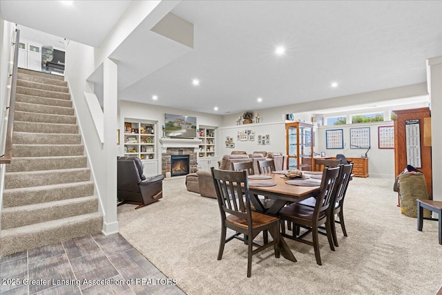 11167 Windswept Dr, Grand Ledge, MI 48837 - carpeted dining room featuring stairs, recessed lighting, and a stone fireplace