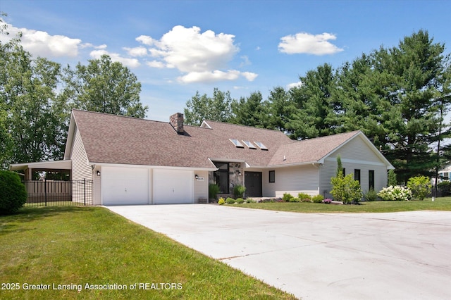 2605 College Rd, Holt, MI 48842 - view of front facade with driveway, an attached garage, a chimney, and roof with shingles