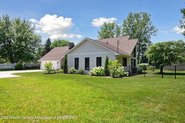 2605 College Rd, Holt, MI 48842 - rear view of house with driveway, a chimney, and a garage