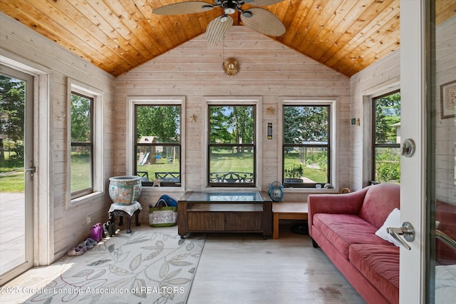 2605 College Rd, Holt, MI 48842 - sunroom with vaulted ceiling, wooden walls, wood ceiling, and wood finished floors