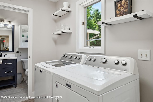 2605 College Rd, Holt, MI 48842 - laundry area featuring washing machine and clothes dryer and light wood finished floors