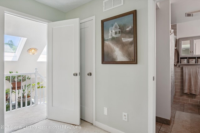 2605 College Rd, Holt, MI 48842 - unfurnished bedroom featuring a skylight and baseboards
