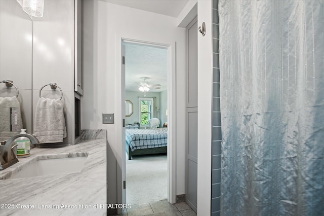 2605 College Rd, Holt, MI 48842 - bathroom with ensuite bath, vanity, curtained shower, and ceiling fan