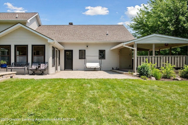 2605 College Rd, Holt, MI 48842 - back of house with a patio and a shingled roof
