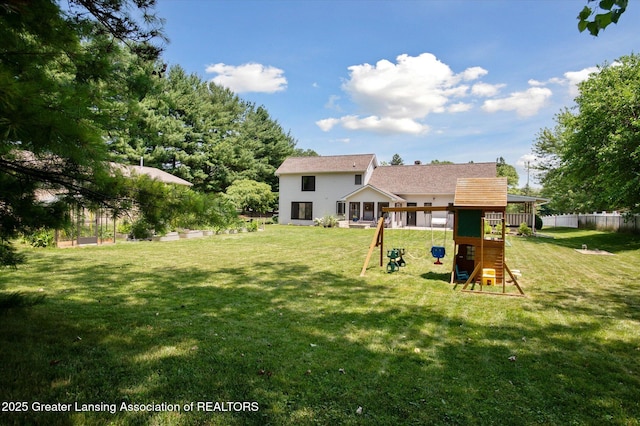 2605 College Rd, Holt, MI 48842 - back of house with a playground