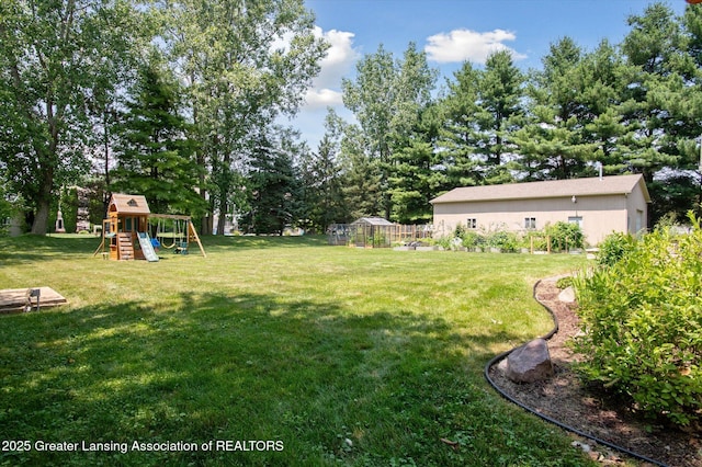2605 College Rd, Holt, MI 48842 - view of green lawn featuring a playground and an outdoor structure