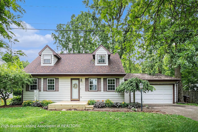 1614 N Eifert Rd, Holt, MI 48842 - cape cod house featuring asphalt driveway, an attached garage, and a shingled roof