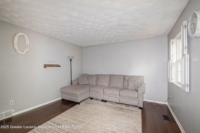 1614 N Eifert Rd, Holt, MI 48842 - living area featuring wood finished floors and a textured ceiling