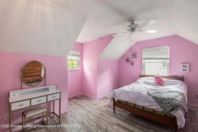 1614 N Eifert Rd, Holt, MI 48842 - bedroom featuring lofted ceiling, wood finished floors, and ceiling fan