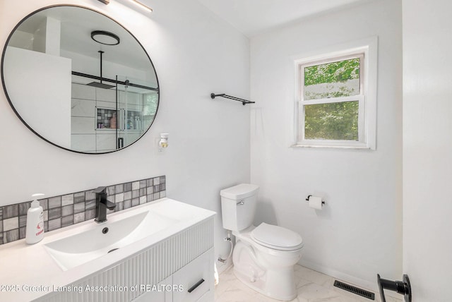 1614 N Eifert Rd, Holt, MI 48842 - bathroom featuring vanity, marble finish floors, and backsplash