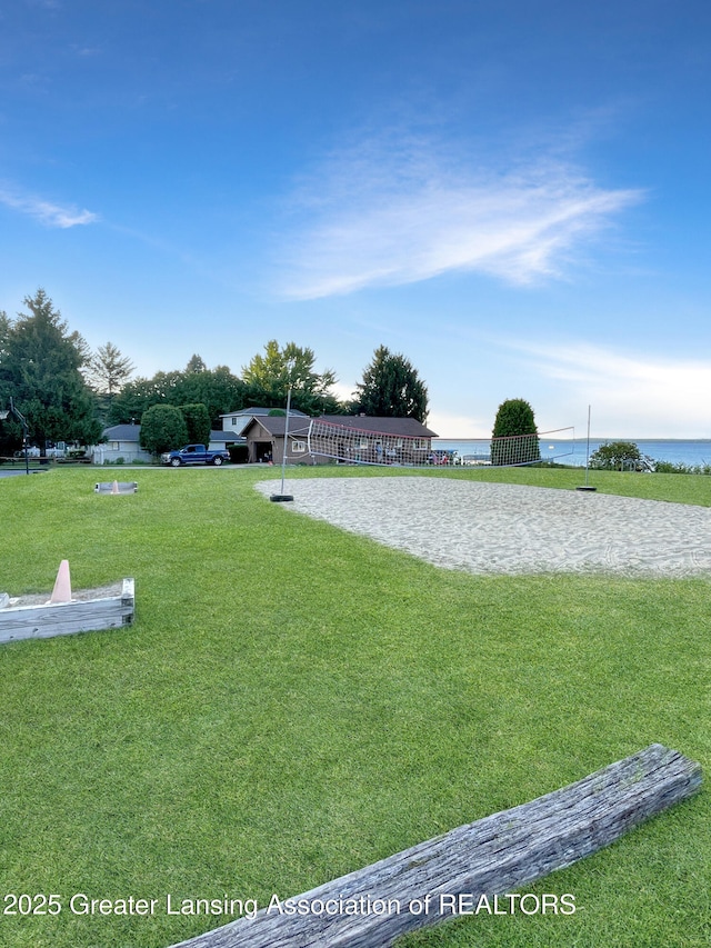 103 Norway Rd, Roscommon, MI 48653 - view of green lawn with volleyball court and a water view