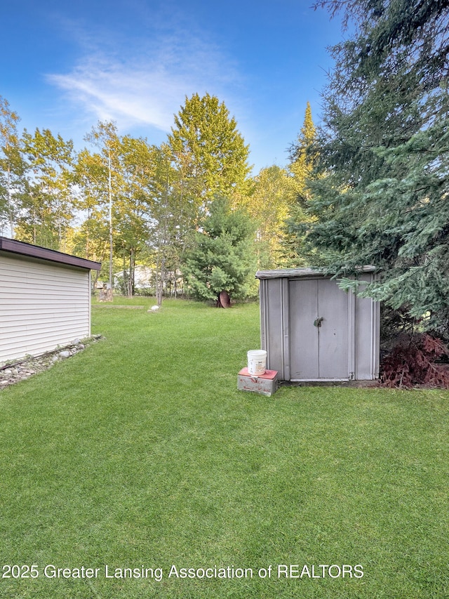 103 Norway Rd, Roscommon, MI 48653 - view of grassy yard with a storage shed