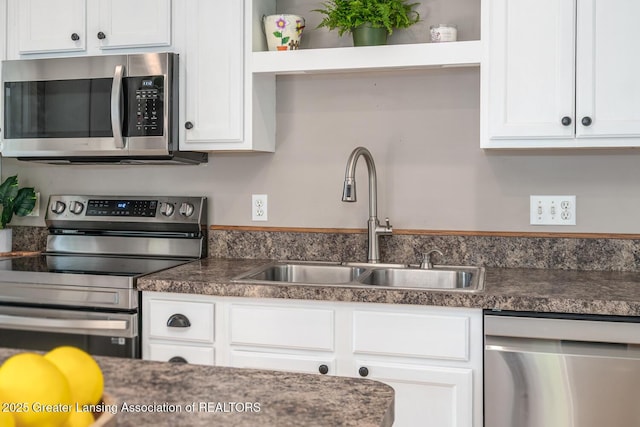 774 Tims View St, Potterville, MI 48876 - kitchen featuring appliances with stainless steel finishes, white cabinets, dark countertops, and open shelves