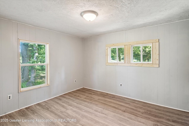 27508 F Dr S, Albion, MI 49224 - unfurnished room with wood finished floors, plenty of natural light, and a textured ceiling