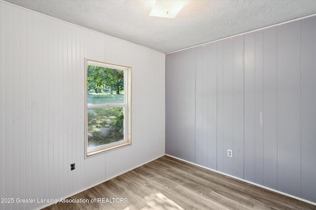 27508 F Dr S, Albion, MI 49224 - unfurnished room featuring wood finished floors and a textured ceiling