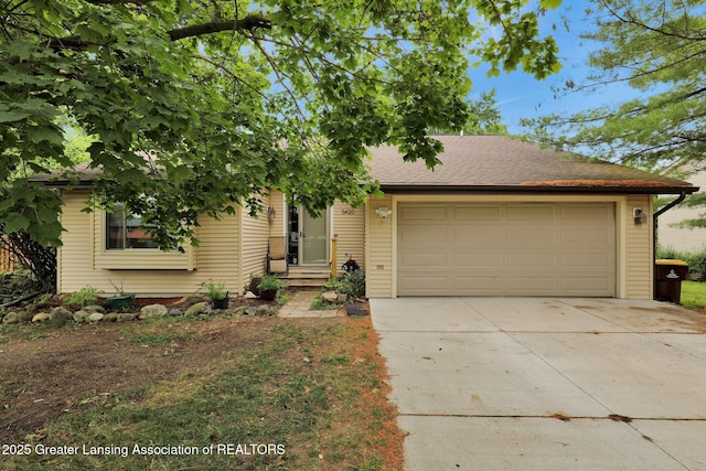 5420 Park Lake Rd, East Lansing, MI 48823 - view of front of home with a garage and concrete driveway