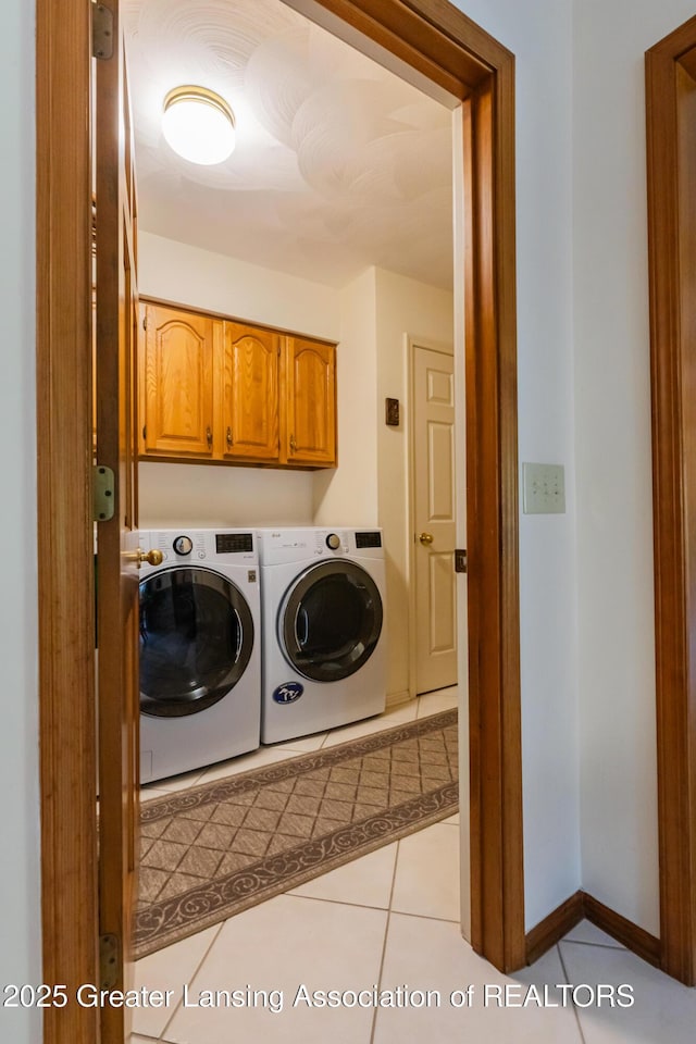 3888 Breckinridge Dr, Okemos, MI 48864 - washroom with separate washer and dryer, light tile patterned flooring, and cabinet space