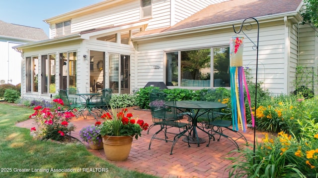 3888 Breckinridge Dr, Okemos, MI 48864 - view of patio / terrace with outdoor dining area and a sunroom