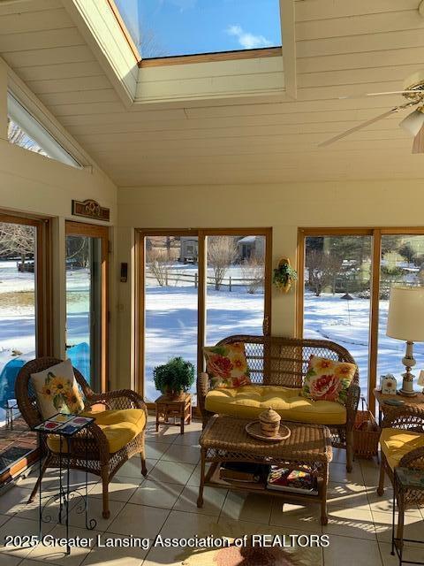 3888 Breckinridge Dr, Okemos, MI 48864 - sunroom featuring tile patterned flooring, lofted ceiling, and a skylight