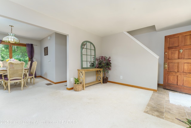 2162 Kent St, Okemos, MI 48864 - dining area with light colored carpet and stairway