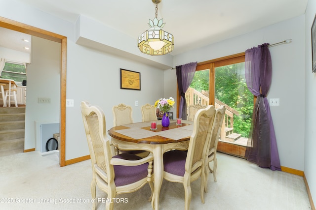 2162 Kent St, Okemos, MI 48864 - dining room with light colored carpet and stairway