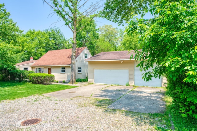 2162 Kent St, Okemos, MI 48864 - view of front of home featuring a garage and a front lawn