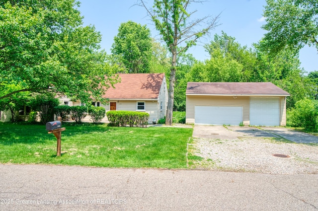 2162 Kent St, Okemos, MI 48864 - view of front of property featuring a detached garage, an outbuilding, and a front yard
