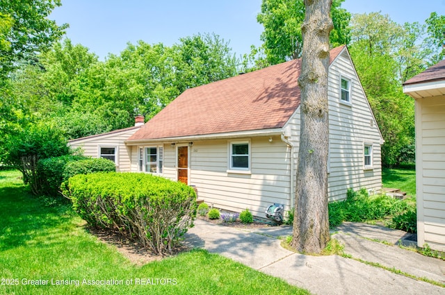 2162 Kent St, Okemos, MI 48864 - back of property featuring roof with shingles and a lawn