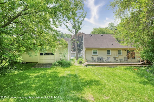 2162 Kent St, Okemos, MI 48864 - back of house featuring a wooden deck, a yard, and an attached garage