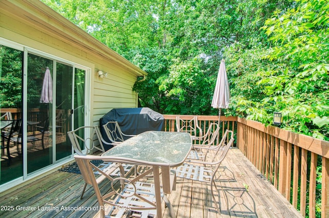 2162 Kent St, Okemos, MI 48864 - wooden deck featuring outdoor dining area, a grill, and view of scattered trees
