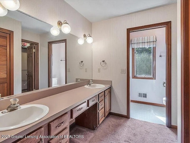 3619 W Arbutus Dr, Okemos, MI 48864 - full bathroom with double vanity and baseboards