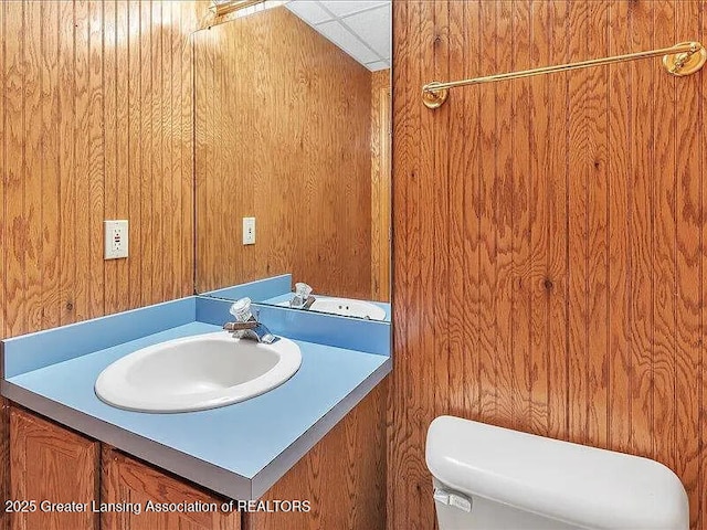 3619 W Arbutus Dr, Okemos, MI 48864 - bathroom with vanity and wood walls