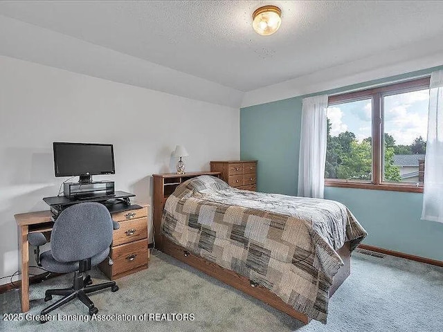 3619 W Arbutus Dr, Okemos, MI 48864 - bedroom with light carpet, a desk, and a textured ceiling