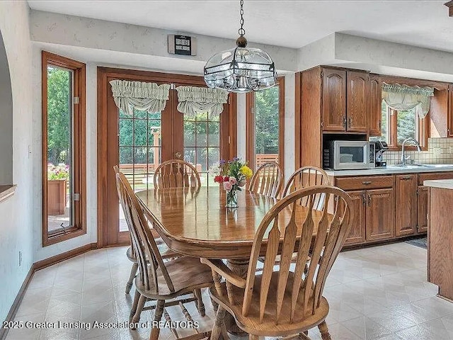 3619 W Arbutus Dr, Okemos, MI 48864 - dining area featuring plenty of natural light and a chandelier