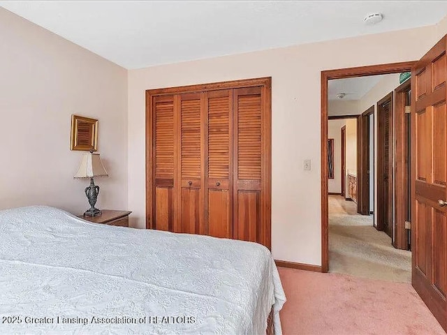 3619 W Arbutus Dr, Okemos, MI 48864 - bedroom with light colored carpet and a closet