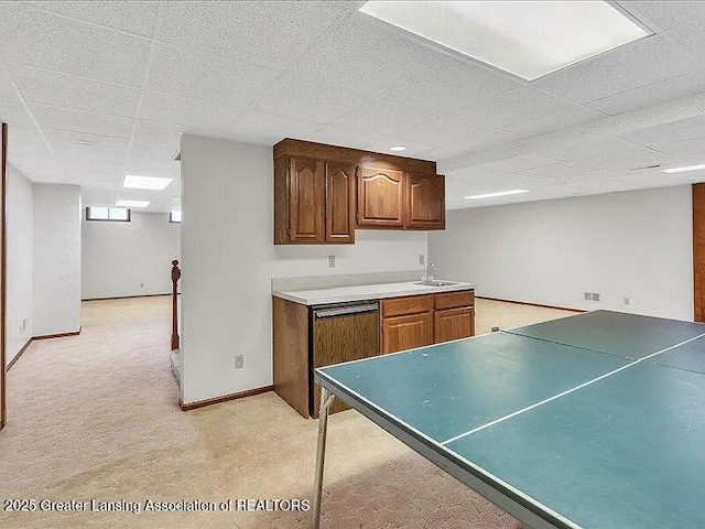 3619 W Arbutus Dr, Okemos, MI 48864 - kitchen with a drop ceiling, light colored carpet, and light countertops