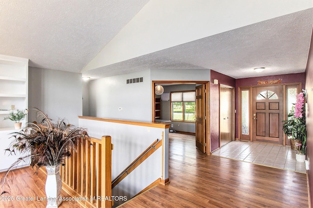 12829 Silver Ridge Dr, Grand Ledge, MI 48837 - entrance foyer featuring a textured ceiling, wood finished floors, and vaulted ceiling