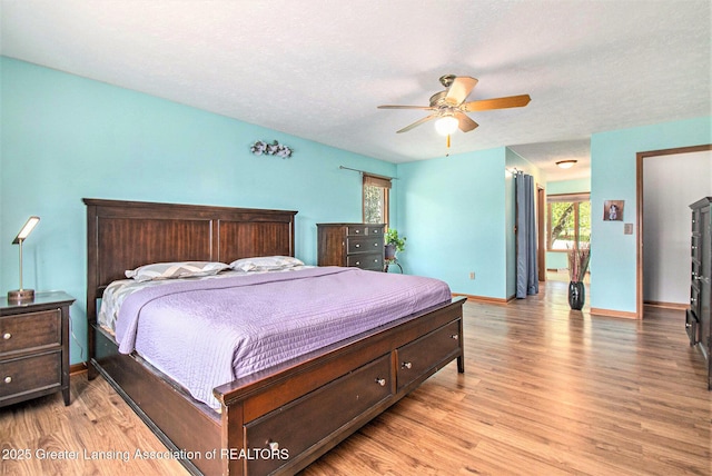 12829 Silver Ridge Dr, Grand Ledge, MI 48837 - bedroom featuring light wood finished floors, ceiling fan, and a textured ceiling