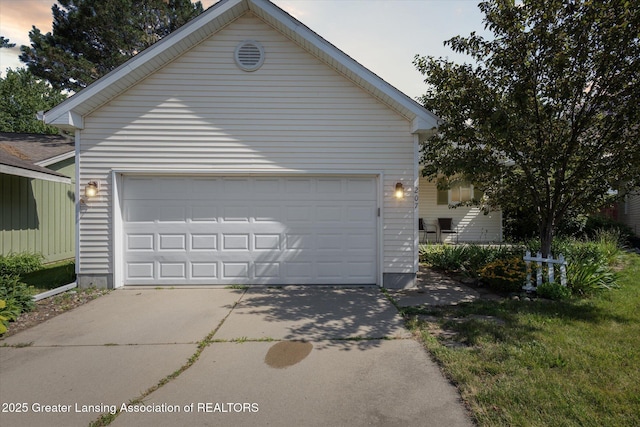 207 Queens Ct Unit 8, Grand Ledge, MI 48837 - view of garage at dusk