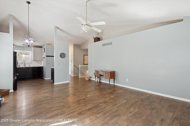 207 Queens Ct Unit 8, Grand Ledge, MI 48837 - unfurnished living room with ceiling fan, dark wood-style floors, high vaulted ceiling, and a chandelier