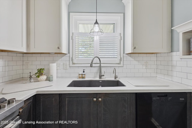 207 Queens Ct Unit 8, Grand Ledge, MI 48837 - kitchen with black dishwasher, light countertops, pendant lighting, and backsplash