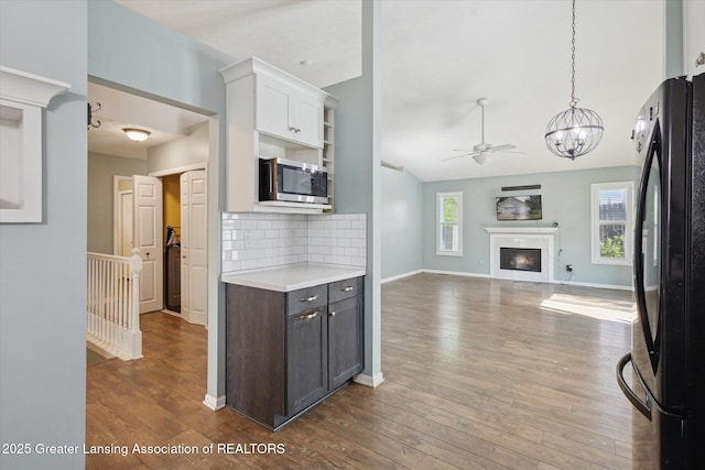 207 Queens Ct Unit 8, Grand Ledge, MI 48837 - kitchen featuring freestanding refrigerator, stainless steel microwave, light countertops, a chandelier, and a ceiling fan