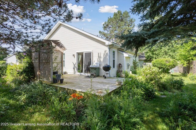 207 Queens Ct Unit 8, Grand Ledge, MI 48837 - rear view of property with a wooden deck and a pergola
