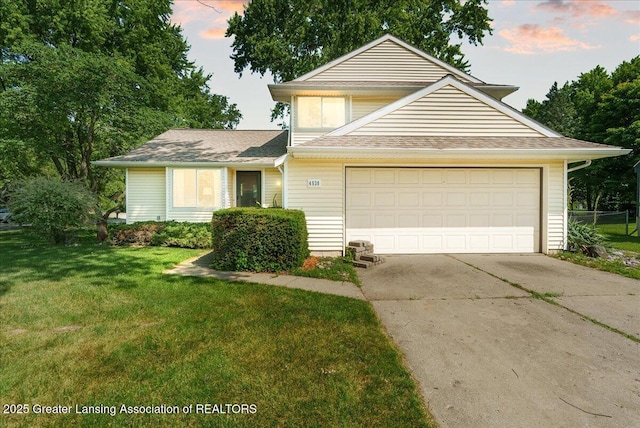 4538 Cranberry Ct, Lansing, MI 48917 - view of front of home featuring concrete driveway, an attached garage, and roof with shingles
